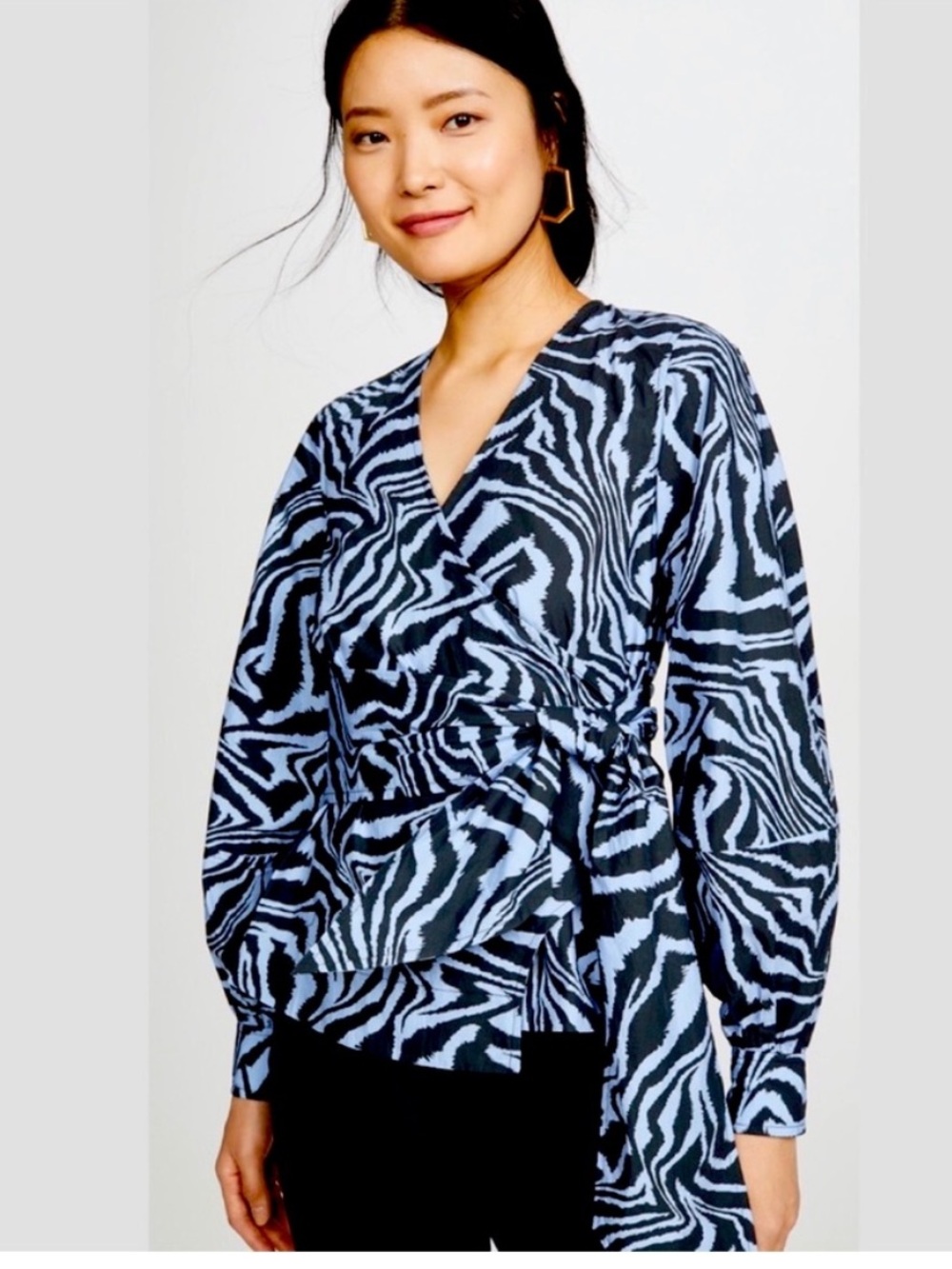 Ganni wrap blouse in their signature swirly tiger print in dusty blue and charco